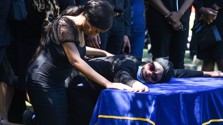 Alexander Kareem&#39;s sister Khafi (left) and mother Victoria during his burial in July