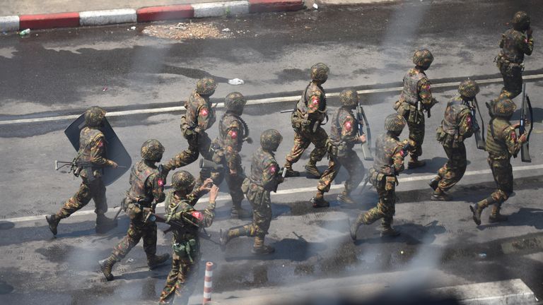 Army officers intervene during a protest against the military coup