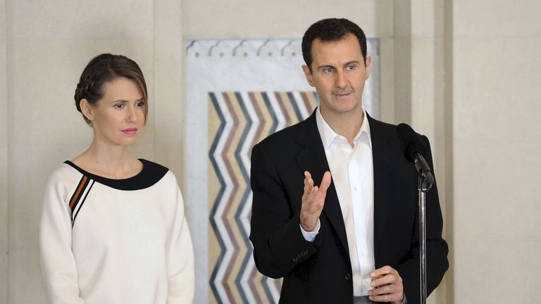 Syria&#39;s President Bashar al-Assad stands next to his wife Asma, as he addresses injured soldiers and their mothers during a celebration marking Syrian Mother&#39;s Day in Damascus