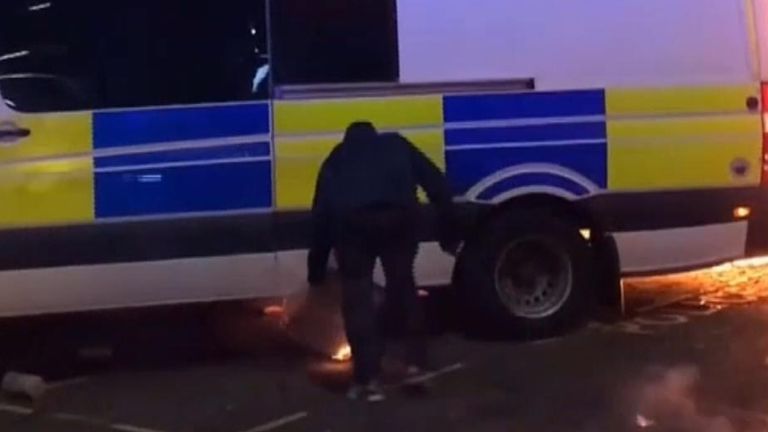 Protester sets police van alight
