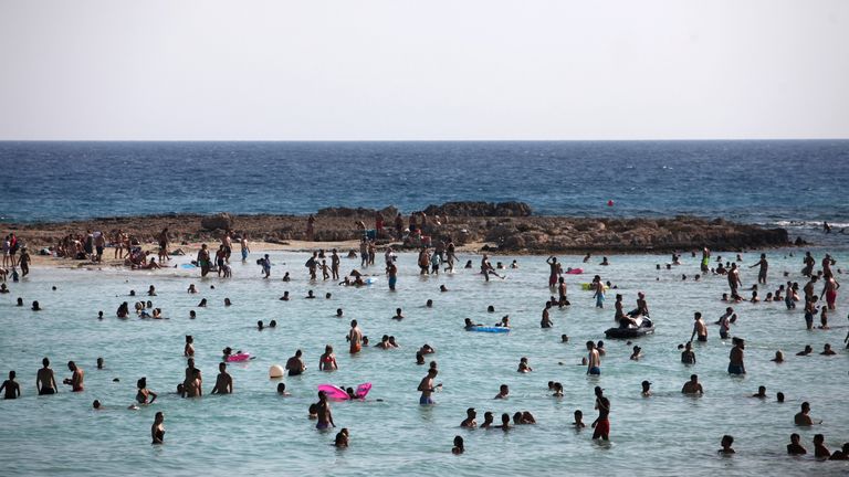 People swimming at a beach in Ayia Napa in 2017