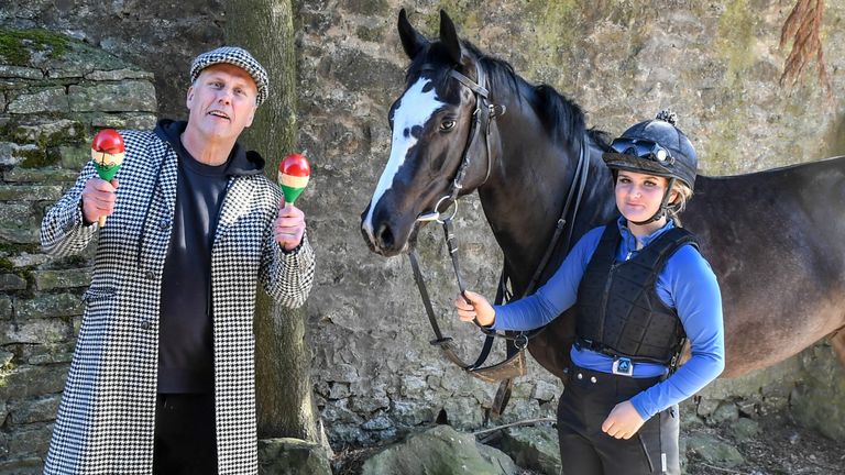 Undated handout photo issued by Bez&#39;s Racing Club of Bez serenading his filly, Mystic Moonshadow and groom Jess Barraclough with some of his maraca magic. Happy Mondays star Bez is launching his own horse racing club ??? despite being a novice in the sport.