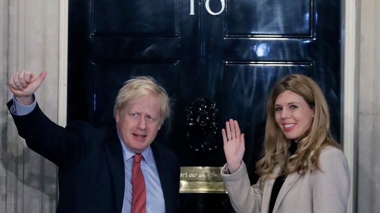 Britain's Prime Minister Boris Johnson and his partner Carrie Symonds wave from the steps of number 10 Downing Street in London, Friday, Dec. 13, 2019. Prime Minister Boris Johnson's Conservative Party has won a solid majority of seats in Britain's Parliament ... a decisive outcome to a Brexit-dominated election that should allow Johnson to fulfill his plan to take the U.K. out of the European Union next month. (AP Photo/Matt Dunham)