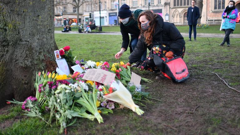 People places flowers at a tree on College Green in Bristol after the Reclaim These Streets vigil for Sarah Everard was officially cancelled. Serving police constable Wayne Couzens, 48, has appeared in court charged with kidnapping and killing the marketing executive, who went missing while walking home from a friend&#39;s flat in south London on March 3. Picture date: Saturday March 13, 2021.