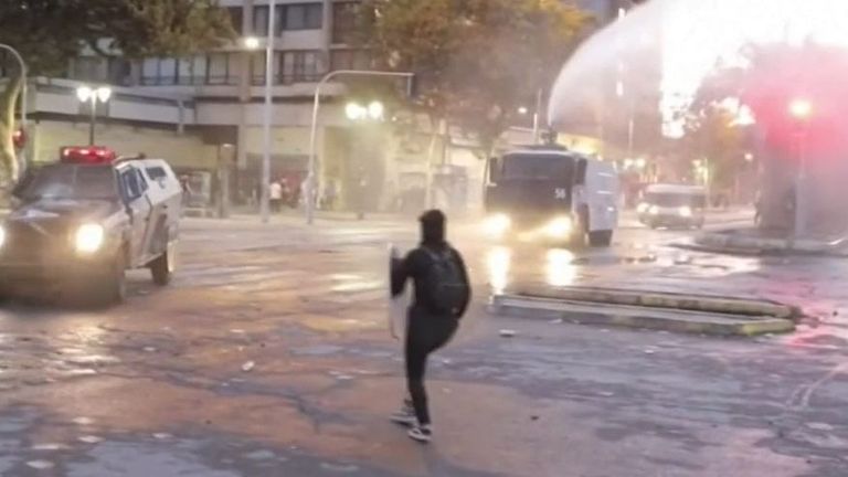 Students protest the re-opening of schools in Chile
