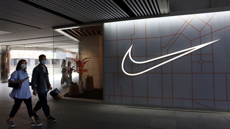 People walk past a Nike store in Beijing