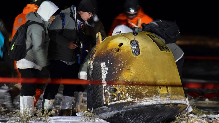 FILE - In this Dec. 17, 2020, file photo released by Xinhua News Agency, recovery crew members check on the capsule of the Chang&#39;e 5 probe after its successful landed in Siziwang district, north China&#39;s Inner Mongolia Autonomous Region. China and Russia said they will build a lunar research station, possibly on the moon&#39;s surface, marking the start of a new era in space cooperation between the two countries. (Ren Junchuan/Xinhua via AP, File)


