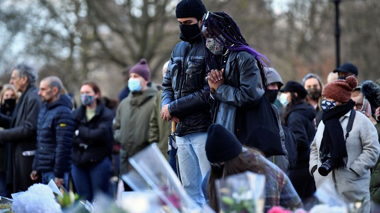 People gather at a memorial site in Clapham Common Bandstand, following the kidnap and murder of Sarah Everard, in London, Britain March 13, 2021. REUTERS/Hannah McKay