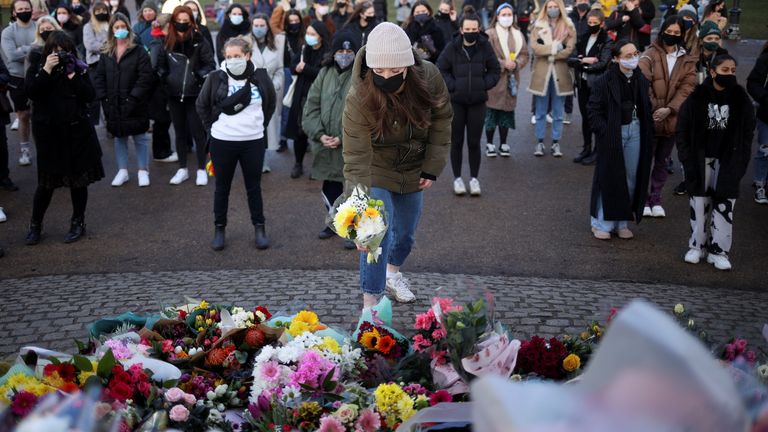 People gather at a memorial site in Clapham Common Bandstand, following the kidnap and murder of Sarah Everard, in London, Britain March 13, 2021. REUTERS/Hannah McKay