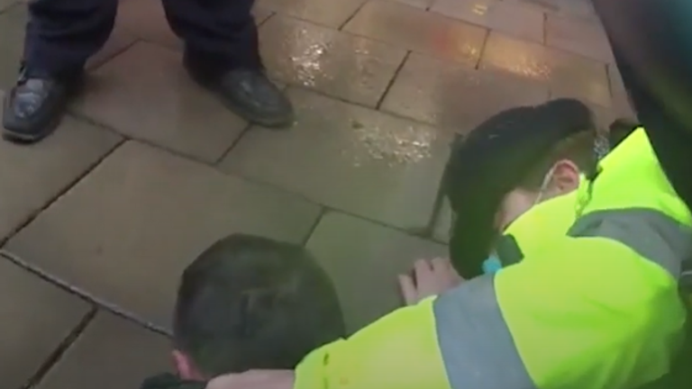 The fugitive had to be restrained on the floor. Pic: West Midlands Police