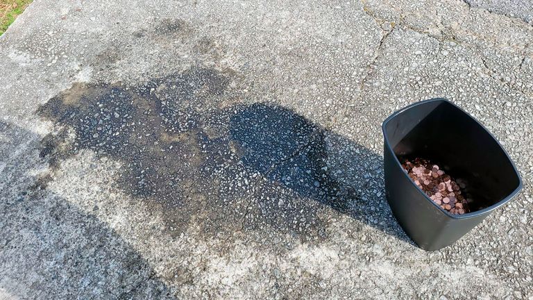 A stain on the drive way where the coins were found. Pic Associated Press