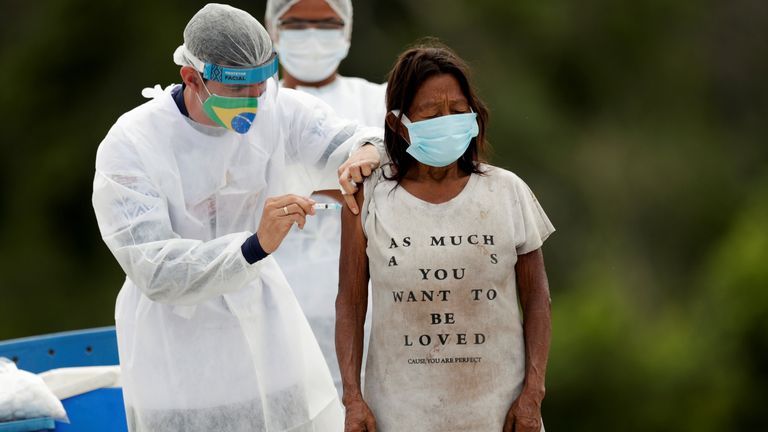 A woman in Amazonas is given a vaccine - but Brazil has vaccinated less than 5% of its population 