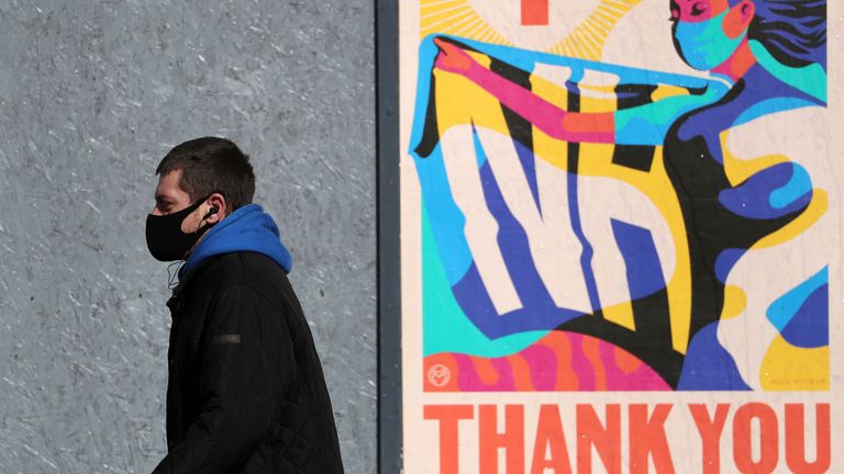 A person walks passed an advertising board in Glasgow showing a Thank You NHS poster, as lockdown measures for mainland Scotland continue. Picture date: Friday March 12, 2021.