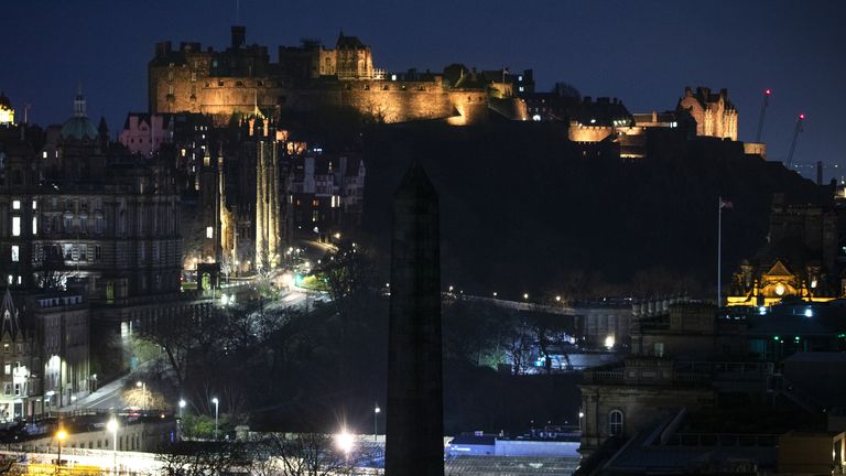 Edinburgh Castle is illuminated yellow during the National Day of Reflection, on the anniversary of the first national lockdown