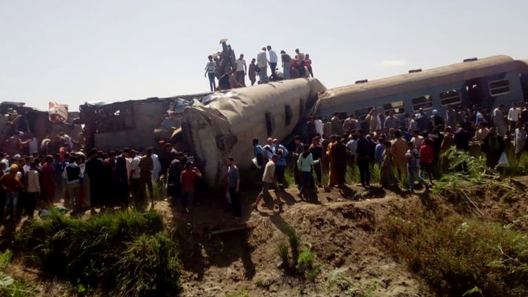 People inspect the damage after two trains have collided near the city of Sohag, Egypt, March 26, 2021. REUTERS/Stringer NO RESALES. NO ARCHIVES