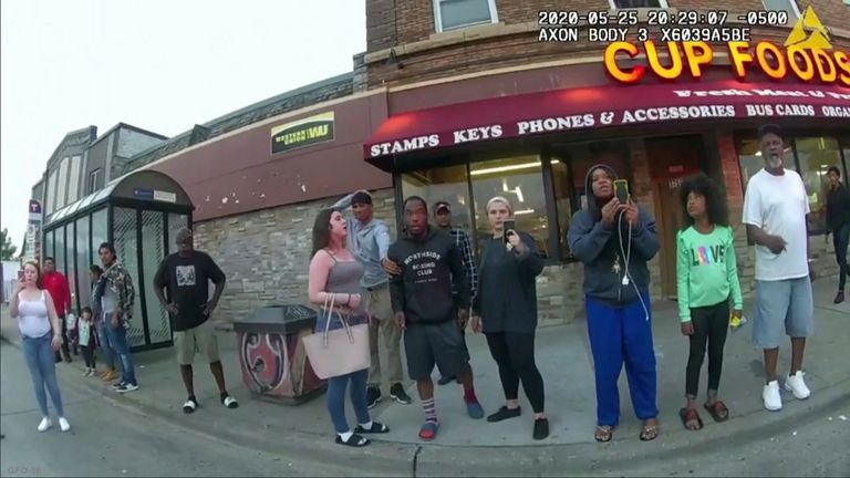 This image from police body camera shows people gathering eas former Minneapolis police officer Derek Chauvin was recorded pressing his knee on George Floyd...s neck for several minutes as onlookers yelled at Chauvin to get off and Floyd gasped that he couldn...t breathe on May 25, 2020 in Minneapolis. From the moment a bystander filmed George Floyd under the knee of Officer Derek Chauvin, video shaped the public&#39;s understanding of Floyd&#39;s death. (Minneapolis Police Department via AP)