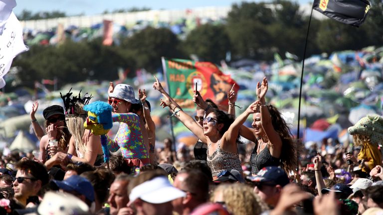 In this Sunday June 30, 2019 file photo, revelers react to Kylie Minogue as she performs at Glastonbury Festival, Somerset, England.  One of Britain's biggest summer music events, the Glastonbury Festival, has been canceled on Wednesday March 18, 2020 due to the coronavirus pandemic.  Organizers say the festival, which is due to take place June 24-28, will be postponed to 2021 (Photo by Grant Pollard/Invision/AP, File)