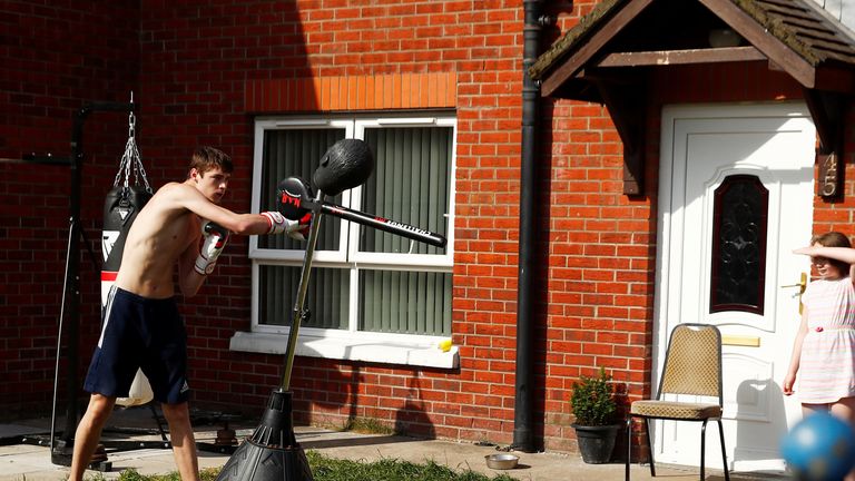 Gerard (17) exercises with boxing equipment at his home as the spread of the coronavirus disease (COVID-19) continues, Belfast, Northern Ireland, April 14, 2020