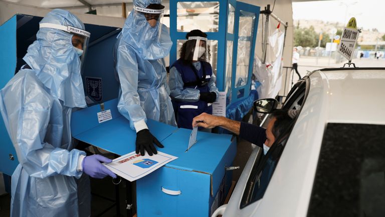 A man votes at a special polling station for Israelis in quarantine or infected with the coronavirus. 