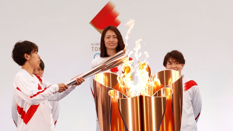 The torch is lit by a member of Japan&#39;s women&#39;s national soccer team