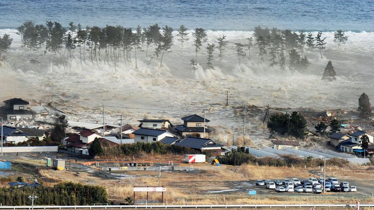 TOKYO, Japan - A massive tsunami engulfs a residential area after a powerful earthquake in Natori, Miyagi Prefecture, northeastern Japan, on March 11, 2011. (Kyodo via AP Images)