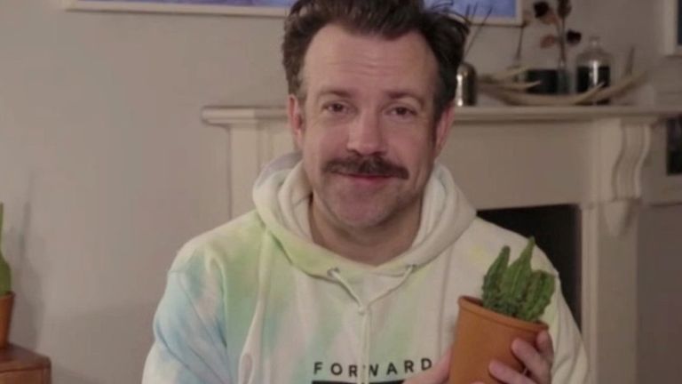 Jason Sudeikis holds a plant at the Golden Globe Awards. Pic: AP
