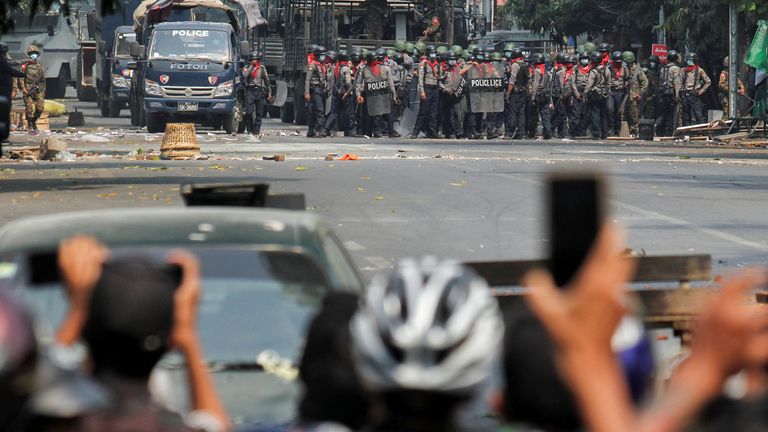 Police stand on a road during an anti-coup protest in Mandalay, Myanmar