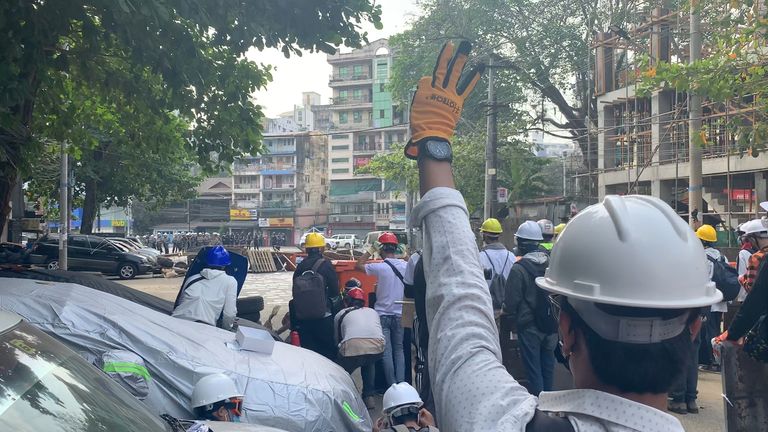 A pro-democracy activist displays the three-finger salute, known to be a symbol of resistance
