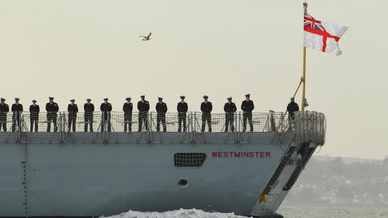 Crew members of The Royal Navy&#39;s Type 23 frigate HMS Westminster, line the deck as it sets sail from Portsmouth Harbour on a seven-month mission to provide security in the Middle East.