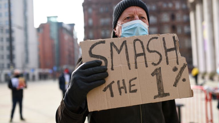 A man takes part in the protest over the proposed 1% pay rise for NHS workers