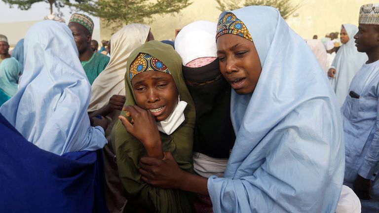 Parents are reunited with their daughter in Jangabe, Nigeria, Wednesday, March 3, 2021. More than 300 schoolgirls kidnapped last week in an attack on their school in northwest Nigeria have arrived in Jangabe after been freed on Tuesday. The Girls were abducted few days ago from Government Girls Secondary School in Jangabe in Zamfara state (AP Photo/Sunday Alamba)