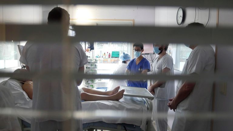 Medical staff meets in a room of a patient affected by COVID-19 virus in the ICU unit at the Ambroise Pare clinic in Neuilly-sur-Seine, near Paris. Pic: AP