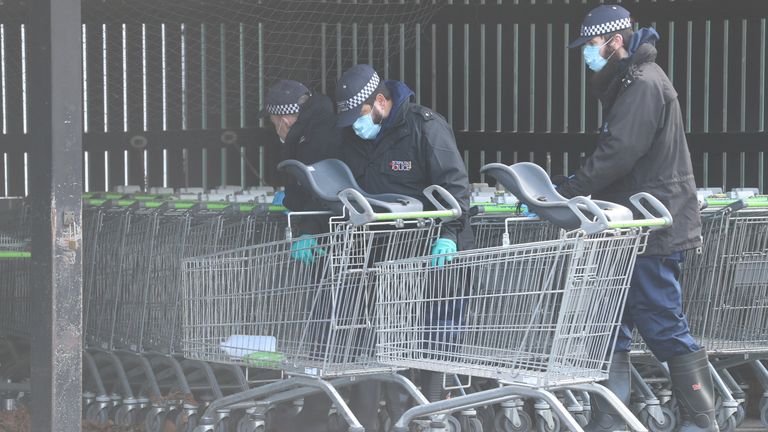 Police examine trolleys at a Co-op in Sandwich, Kent