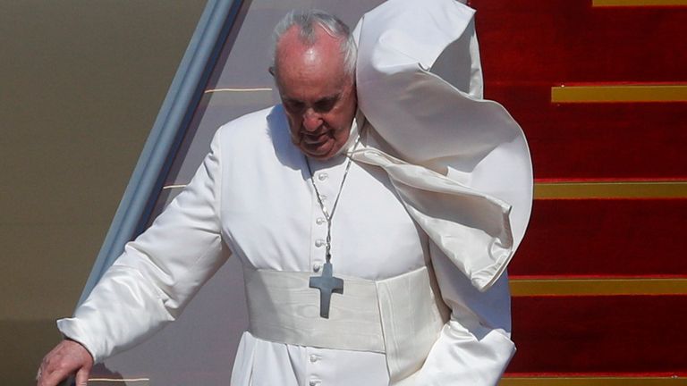 Pope Francis disembarks a plane as he arrives at Baghdad International Airport where a welcoming ceremony is held to start his historic tour in Baghdad, Iraq, March 5, 2021. REUTERS/Yara Nardi