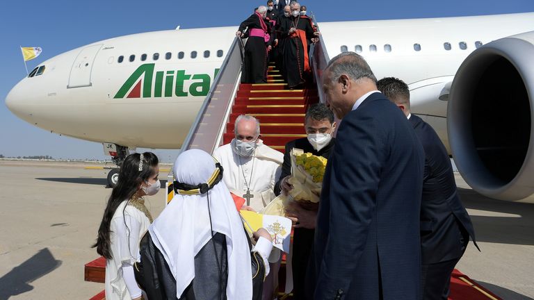 The pontiff was welcomed by two children in traditional dress