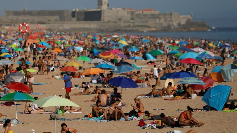 People enjoy the sunny weather at Carcavelos beach, amid the coronavirus disease (COVID-19) outbreak, near Lisbon, Portugal, July 11, 2020. REUTERS/Rafael Marchante

