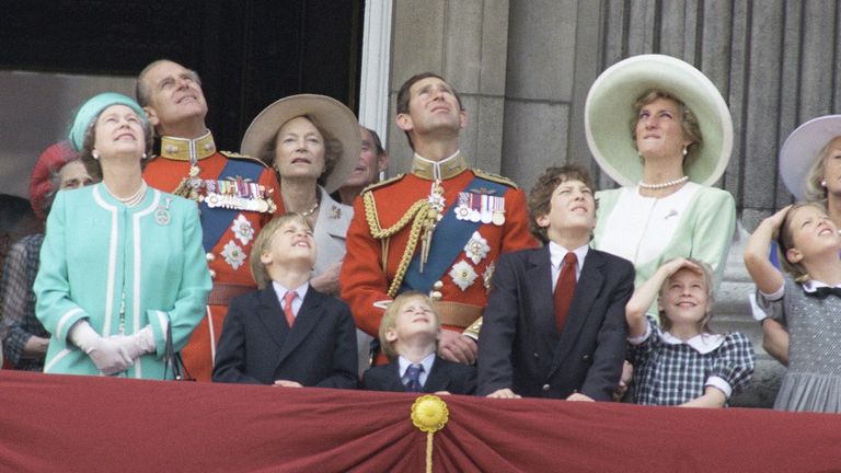 Members of the British Royal Family, including Queen Elizabeth II, Prince Philip, The Prince and Princess of Wales, Princess William and Harry (center), watch a fly past to mark the Queen&#39;s official birthday, from the balcony of Buckingham Palace, Saturday, June 16,1990. Others are unidentified. (AP Photo)