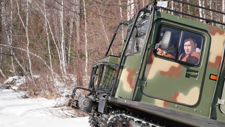 Russian President Vladimir Putin drives a tracked all-terrain vehicle. Pic: AP