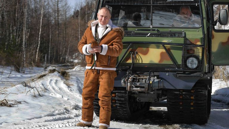  Putin poses for a photo in front of a tracked all-terrain vehicle
