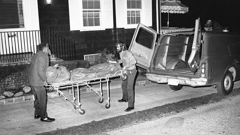 This was the scene on New York’s Long Island at night on Wednesday, Nov. 14, 1974 in Amityville, N.Y. at the house where the six bodies of the Ronald DeFeo family were found slain. The Suffolk Country Sheriff is investigating the slayings at the DeFeo house named “High Hopes.” (AP Photo/RED)