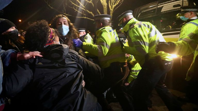 People clash with police during a gathering at a memorial site in Clapham Common Bandstand, following the kidnap and murder of Sarah Everard, in London, Britain March 13, 2021. REUTERS/Hannah McKay
