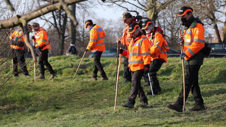 Volunteers from London Search and Rescue near Eagle Pond on Clapham Common