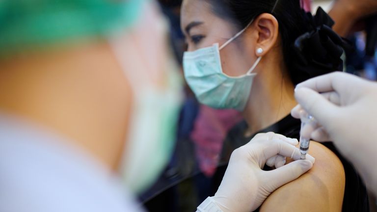 A woman receives the Sinovac coronavirus disease (COVID-19) vaccine at the Samut Sakhon hospital in Samut Sakhon province, Thailand, February 28, 2021. REUTERS/Athit Perawongmetha