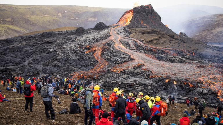 People gather at the volcanic site on the Reykjanes Peninsula following Friday&#39;s eruption in Iceland, March 21, 2021. Picture taken March 21, 2021. REUTERS/Cat Gundry-Beck NO RESALES. NO ARCHIVES