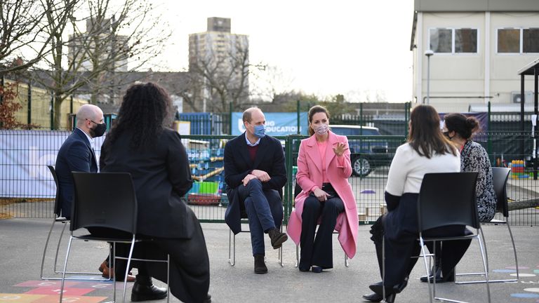 The Duke and Duchess of Cambridge speak with teachers during a visit to a school in Stratford, east London