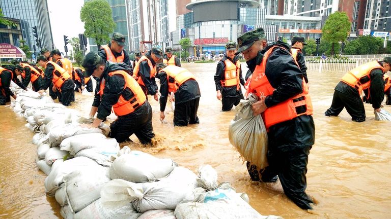 Officials help ease flooding in Wuhan in July 2016