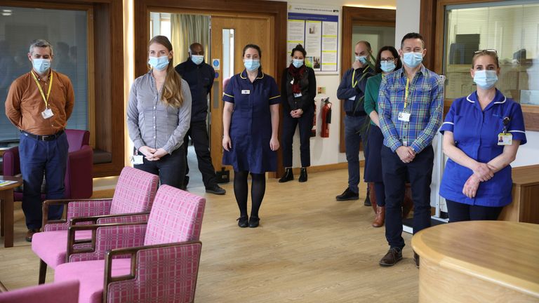 Healthcare workers and staff members observe a minute of silence during the day of reflection to mark the anniversary of Britain&#39;s first coronavirus disease (COVID-19) lockdown, at the Marie Curie Hospice in Hampstead, in London, Britain, March 23, 2021. REUTERS/Tom Nicholson