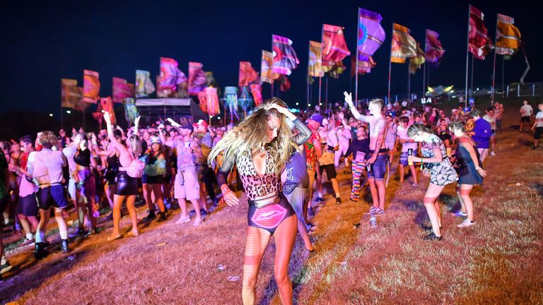 Revelers dance in the Temple Field at Bestival at the Lulworth Estate in Dorset.