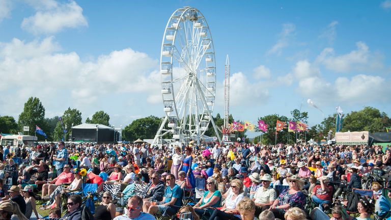 Festival-goers relax in the main stage arena on day four of the Isle of Wight Festival 2017, at Seaclose Park, Isle of Wight.