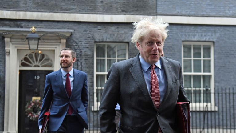 Prime Minister Boris Johnson, accompanied by Cabinet Secretary Simon Case (left), crosses Downing Street as he arrives for the government's weekly Cabinet meeting at the Foreign and Commonwealth Office (FCO).